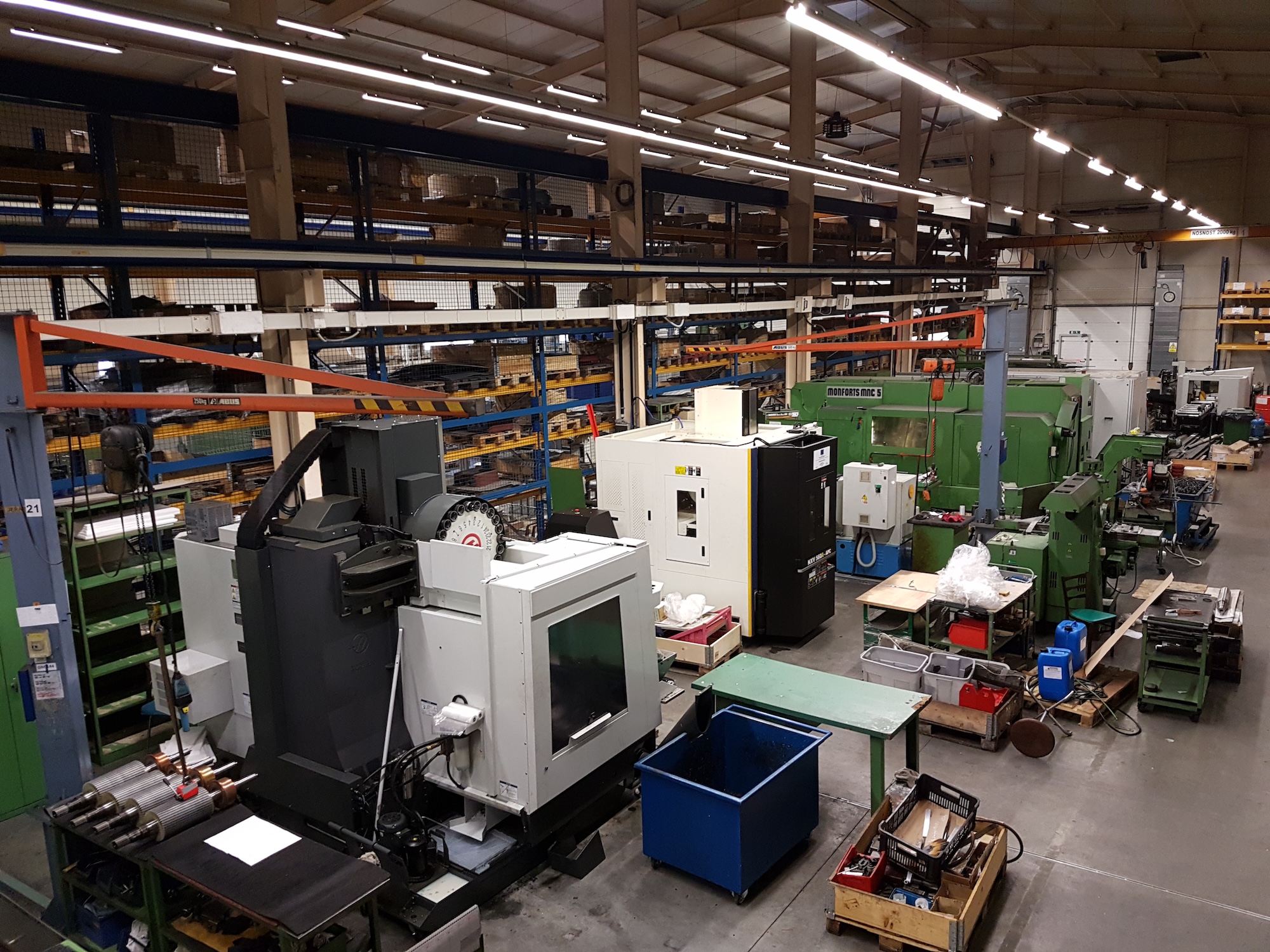 precision CNC machining center, 5-axis milling machine, industrial metalworking equipment, blue technical lighting, close-up view